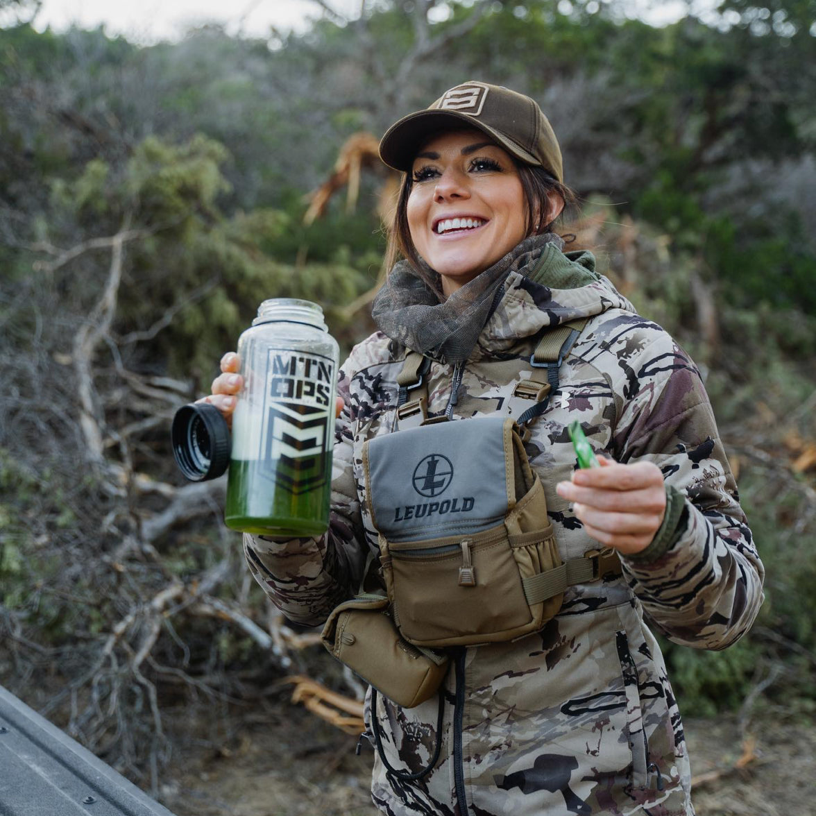 Woman standing with a MTN OPS drink